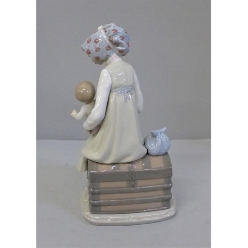 605 - A Lladro figure of a Mother feeding her baby, 23cm