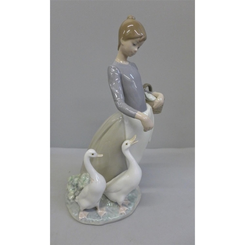 606 - A Lladro figure, Pacing the Ducks, 25cm