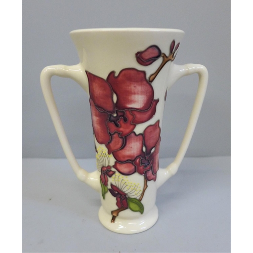 608 - A Moorcroft Orchid pattern loving cup, 16cm