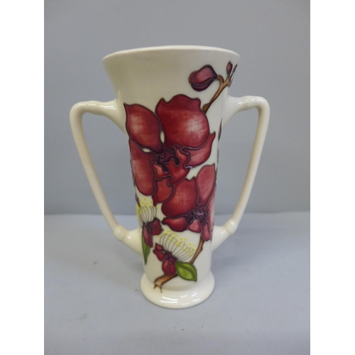 608 - A Moorcroft Orchid pattern loving cup, 16cm