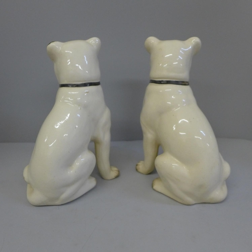 613 - A pair of pottery models of pugs, 24cm