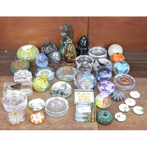 680 - A quantity of glass paperweights