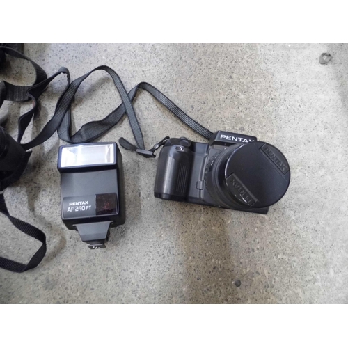 708 - A pair of binoculars, Pentax 35mm film camera, etc.