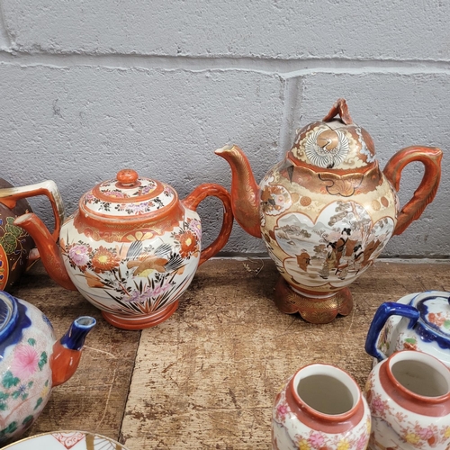 793 - Oriental teawares, Satsuma teapots, a pair of vases, saucers and tea plates