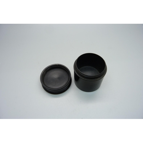 885 - A circular silver mounted ebony pot with screw lid, lid a/f