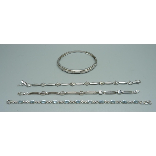 913 - Three silver bracelets and a silver bangle