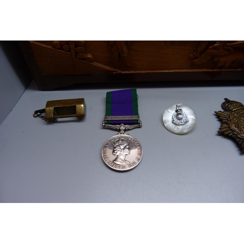 944 - A carved wooden box, a military beret with cap badge, other badges and a For Campaign Service medal ... 