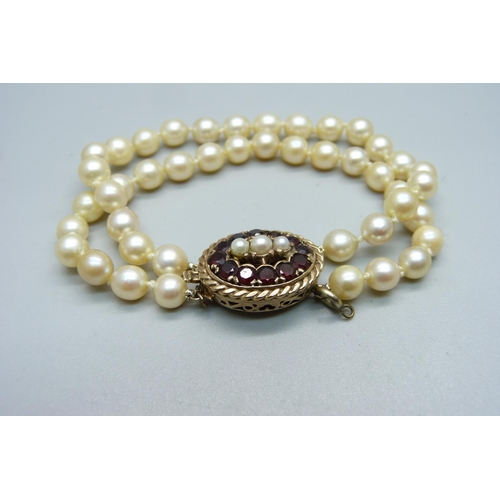 965 - A pearl bracelet with 9ct gold, garnet and pearl clasp