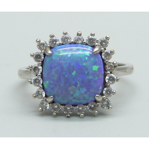 973 - A silver ring set with CZ and a synthetic opal, R