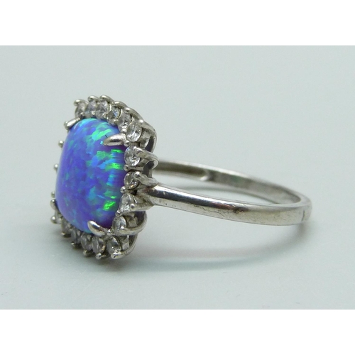 973 - A silver ring set with CZ and a synthetic opal, R