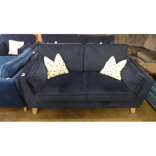 1431 - A Barker and Stonehouse deep blue velvet three seater sofa with patterned scatter cushions