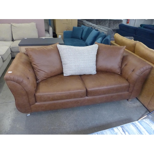 1499 - A dark tan vegan leather upholstered three seater sofa with contrasting scatter back cushion