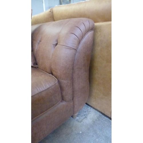 1499 - A dark tan vegan leather upholstered three seater sofa with contrasting scatter back cushion