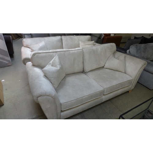 1564 - A pair of champagne velvet upholstered three seater sofas