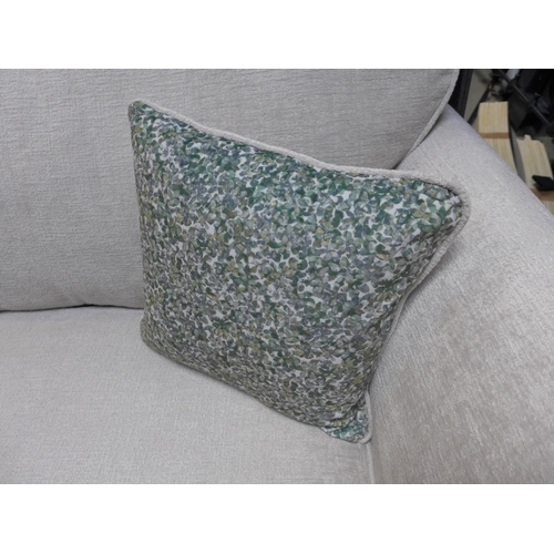 1570 - A Bone upholstered three seater sofa with green patterened scatter cushions