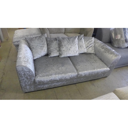 1586 - A silver crushed velvet three seater sofa and footstool