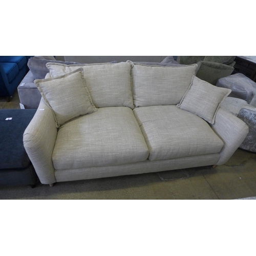 1588 - A champagne upholstered four seater sofa