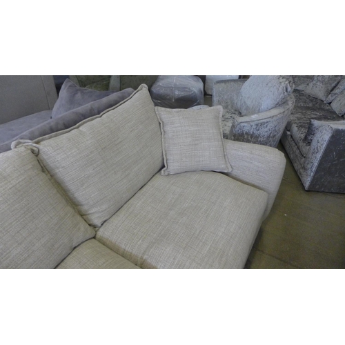 1588 - A champagne upholstered four seater sofa