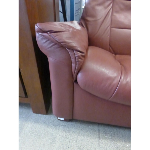 1615 - A red leather two seater push back reclining sofa