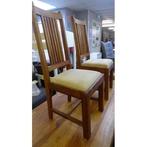 1622 - An Indian hardwood fixed top dining table with a set of six cream upholstered dining chairs