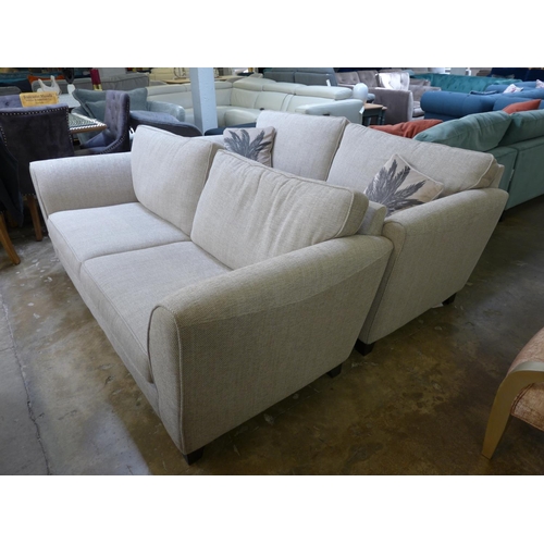 1446 - A pair of champagne textured weave, three seater sofas with palm leaf scatter cushions