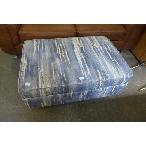 1500 - A blue, white and grey upholstered ottoman footstool