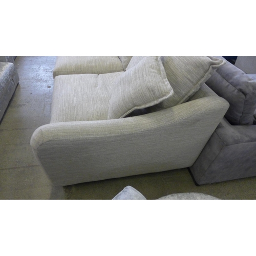 1588 - A champagne upholstered four seater sofa