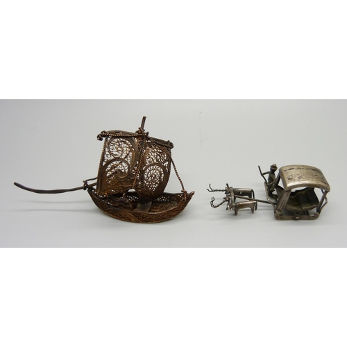 1012 - A miniature white metal carriage and an oriental filigree boat