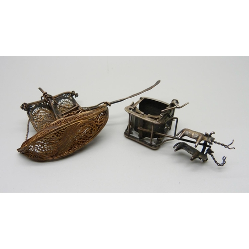 1012 - A miniature white metal carriage and an oriental filigree boat