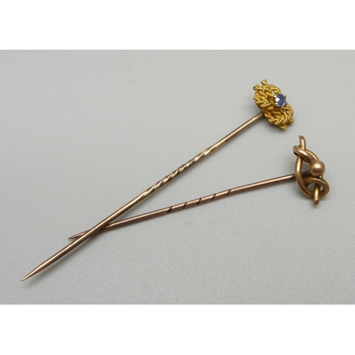 1022 - A 15ct gold and sapphire set pin and a 9ct gold pin