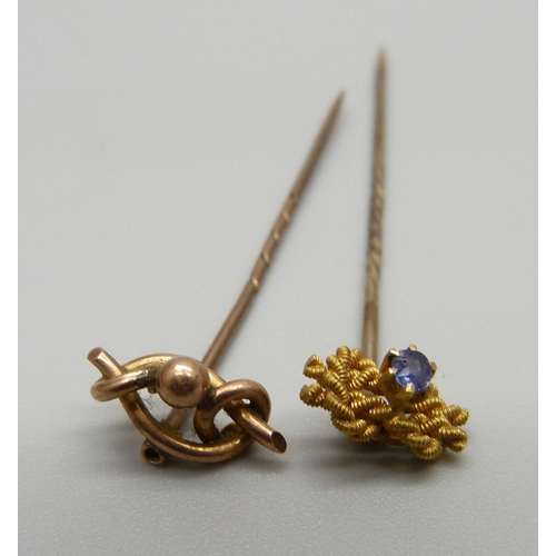 1022 - A 15ct gold and sapphire set pin and a 9ct gold pin