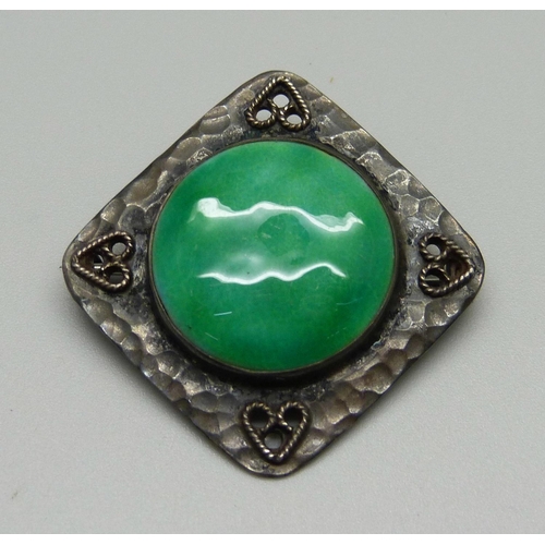 1028 - A hammered sterling silver brooch with Ruskin style plaque