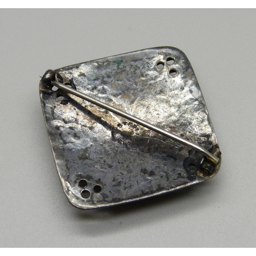 1028 - A hammered sterling silver brooch with Ruskin style plaque