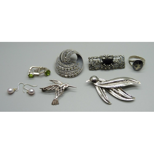 1050 - Four brooches, two pairs of earrings and a ring, (all text as silver, one brooch hallmarked) 39gm