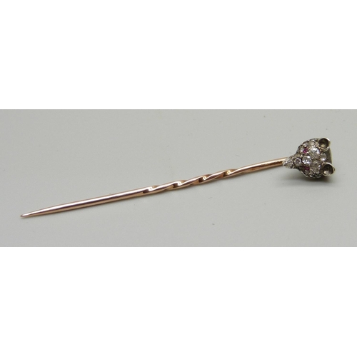 1052 - A Victorian diamond set fox head stick pin with ruby set eyes, (silver set gold pin)