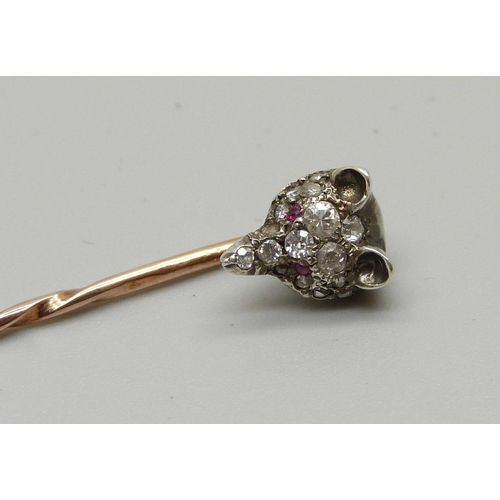 1052 - A Victorian diamond set fox head stick pin with ruby set eyes, (silver set gold pin)