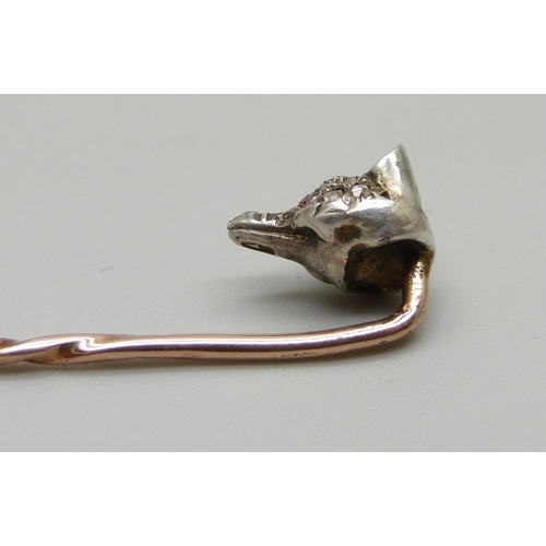 1052 - A Victorian diamond set fox head stick pin with ruby set eyes, (silver set gold pin)