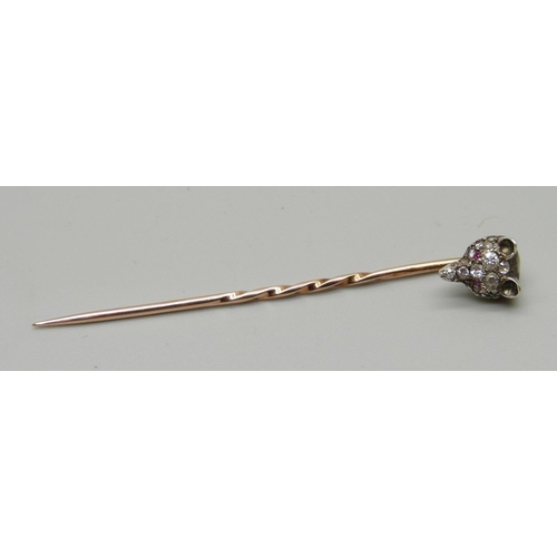 1052 - A Victorian diamond set fox head stick pin with ruby set eyes, (silver set gold pin)