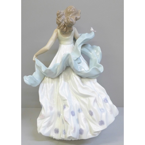 615 - A Lladro figure of a woman with bird, Summer Serenade, 31.5cm