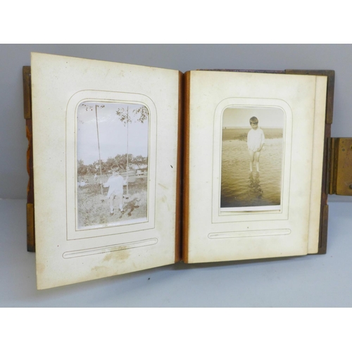 657 - A Victorian CDV album containing early 20th Century black and white photographs (no CDVs), album a/f... 