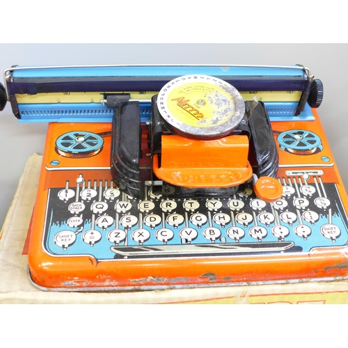 689 - A tin plate Mettype Junior typewriter, boxed and two 1940s Japanese tin plate toys, Smokey Bill and ... 