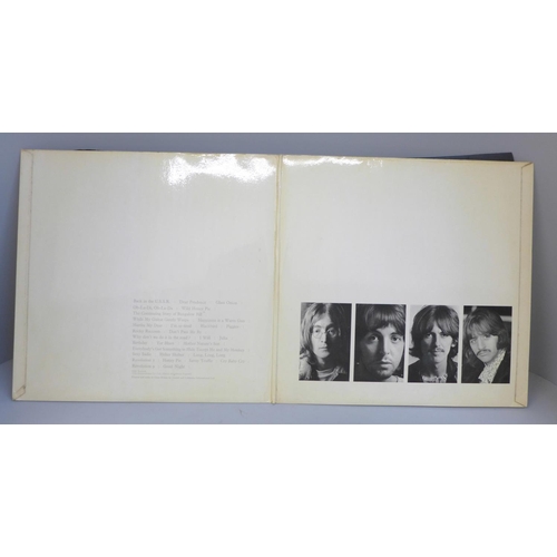 692 - The Beatles White Album, no. 0428266, with original black inner sleeves, poster and four photographs