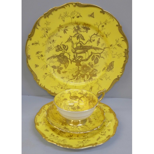 722 - A Coalport yellow and gold Cairo bird trio and dinner plate