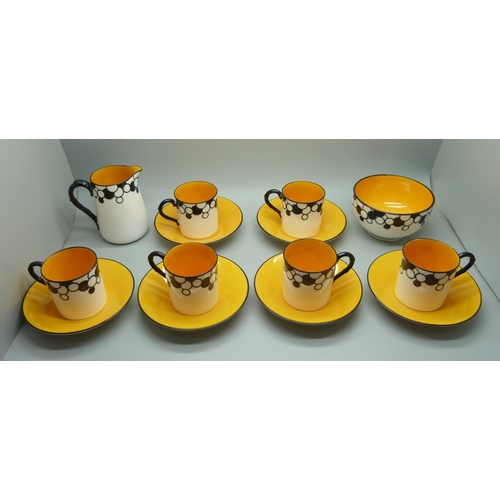 728A - A Royal Worcester six setting Art Deco coffee service, one cup cracked, with six coffee bean spoons