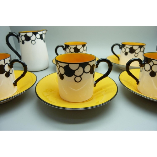 728A - A Royal Worcester six setting Art Deco coffee service, one cup cracked, with six coffee bean spoons