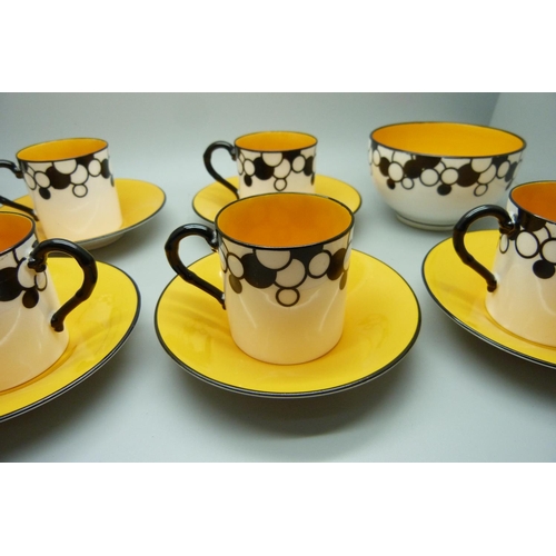 728A - A Royal Worcester six setting Art Deco coffee service, one cup cracked, with six coffee bean spoons