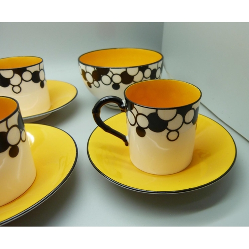 728A - A Royal Worcester six setting Art Deco coffee service, one cup cracked, with six coffee bean spoons