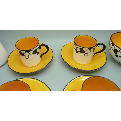 728A - A Royal Worcester six setting Art Deco coffee service, one cup cracked, with six coffee bean spoons