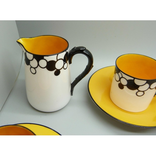 728A - A Royal Worcester six setting Art Deco coffee service, one cup cracked, with six coffee bean spoons