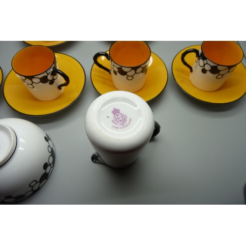 728A - A Royal Worcester six setting Art Deco coffee service, one cup cracked, with six coffee bean spoons